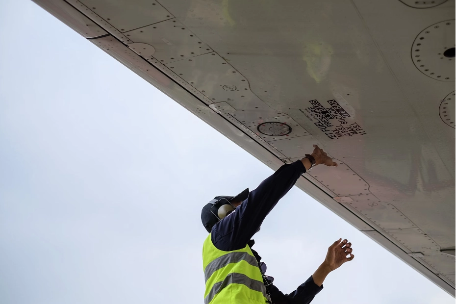 A technician conducting maintenance checks on an aircraft